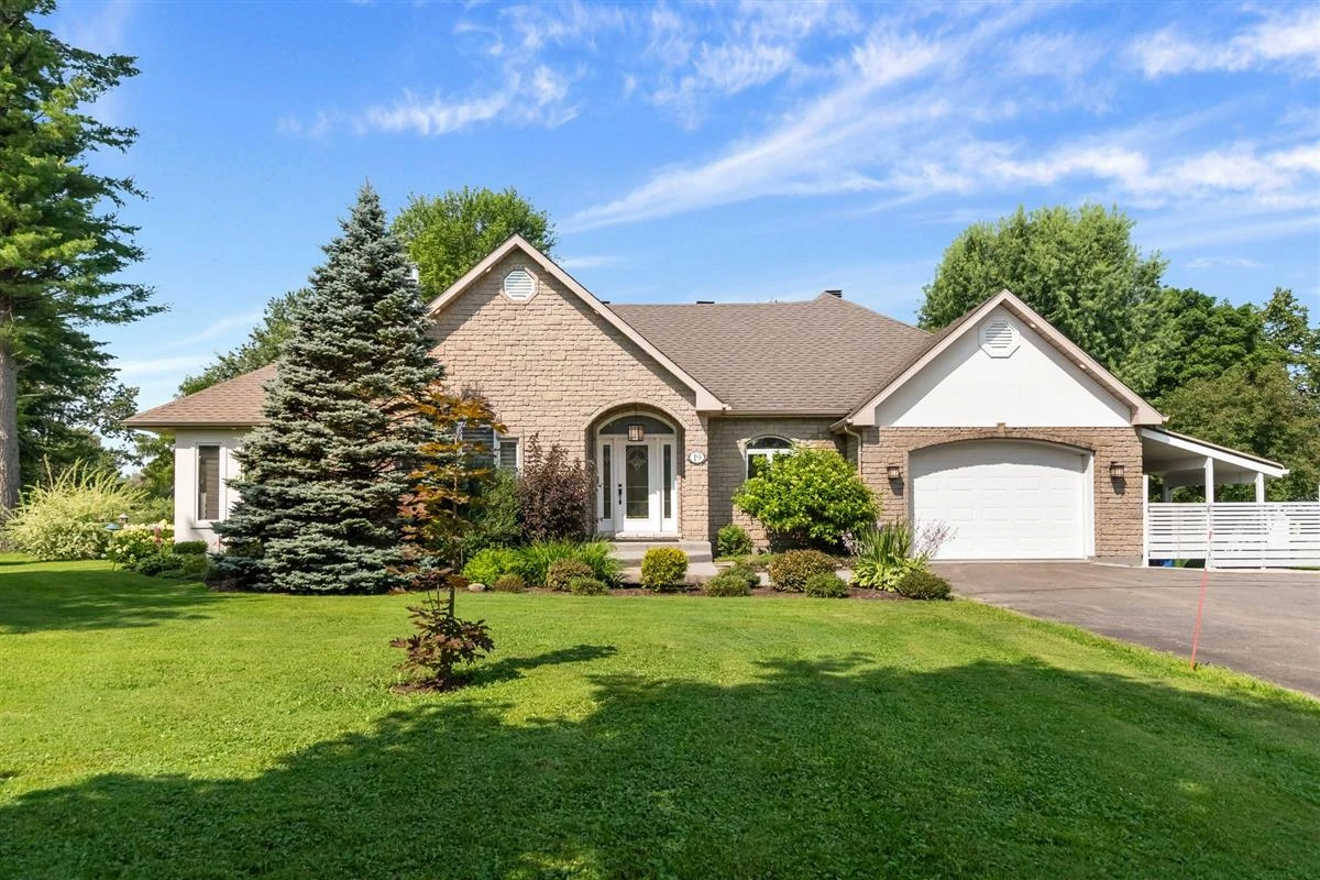 Brick bungalow with attached garage and a large landscaped lot in a Saint-Jérôme residential area