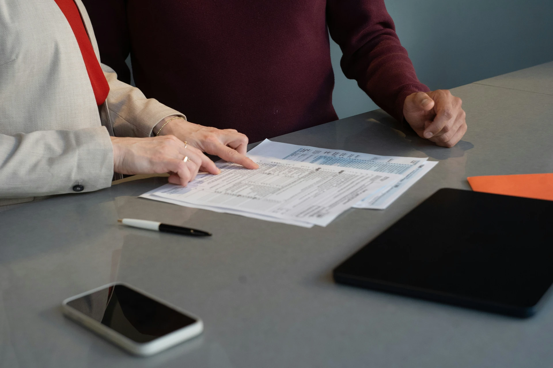 Two people reviewing the financial statements and documents of a co-ownership before a purchase